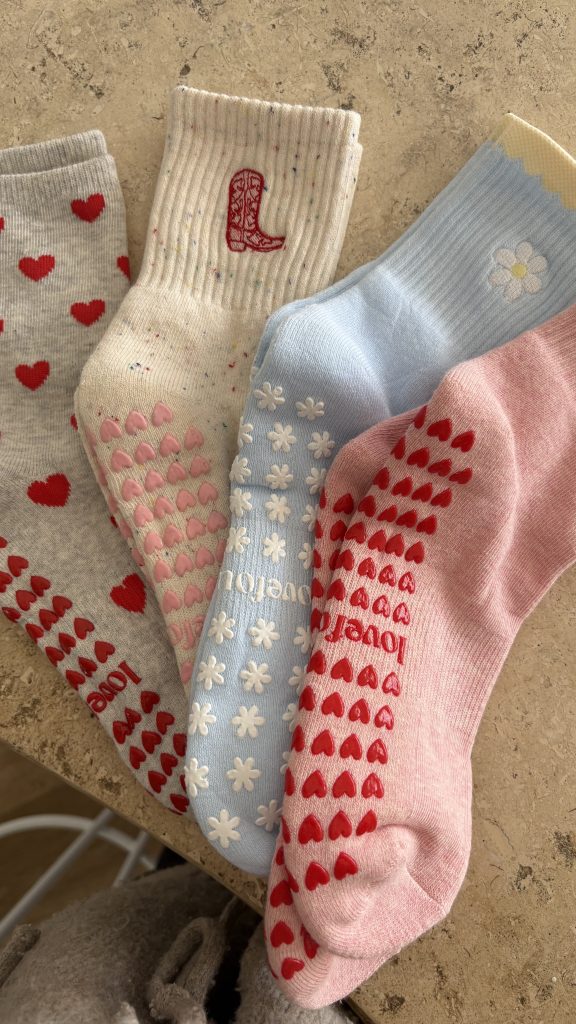 Four colourful patterned socks laid out