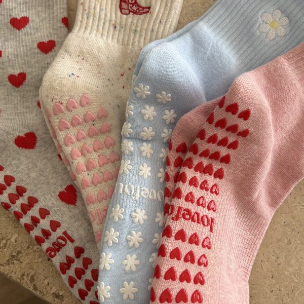 Four colourful patterned socks laid out