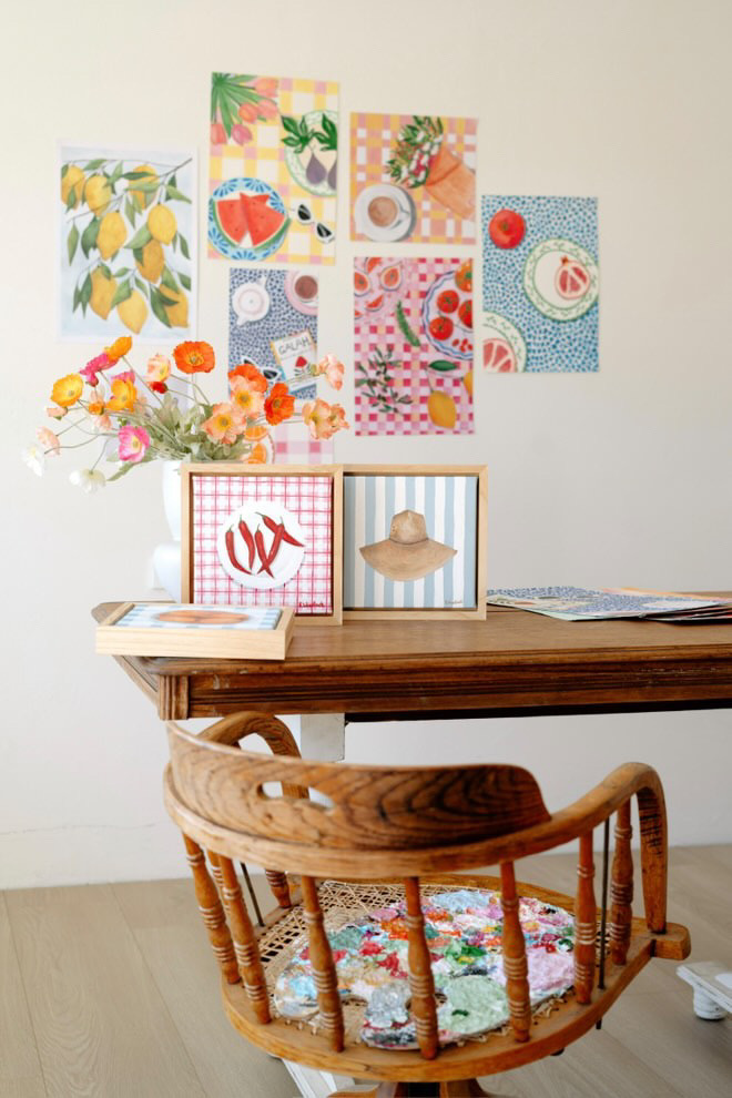 Brightly decorated table with floral arrangement and art.