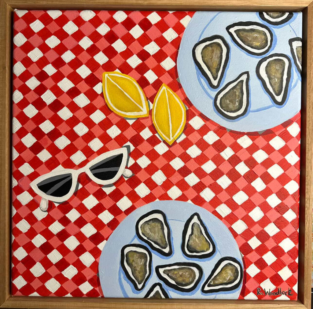Oysters and lemons on a checkered tablecloth.