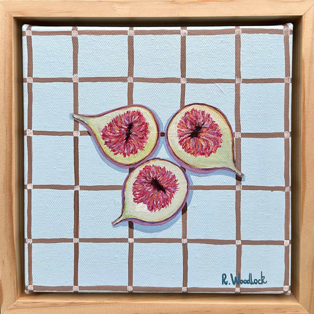 Three sliced figs on a blue checkered background