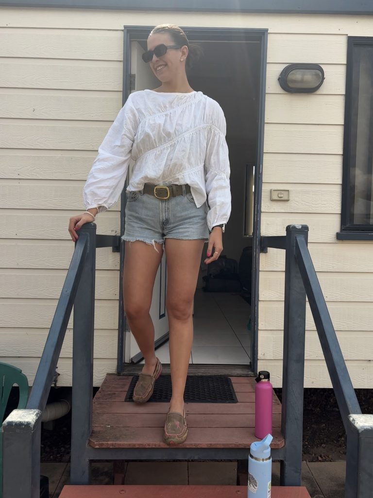 Woman in casual outfit stepping down stairs